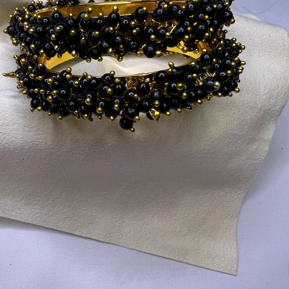 Jewelry - Golden band bracelet with black beads.